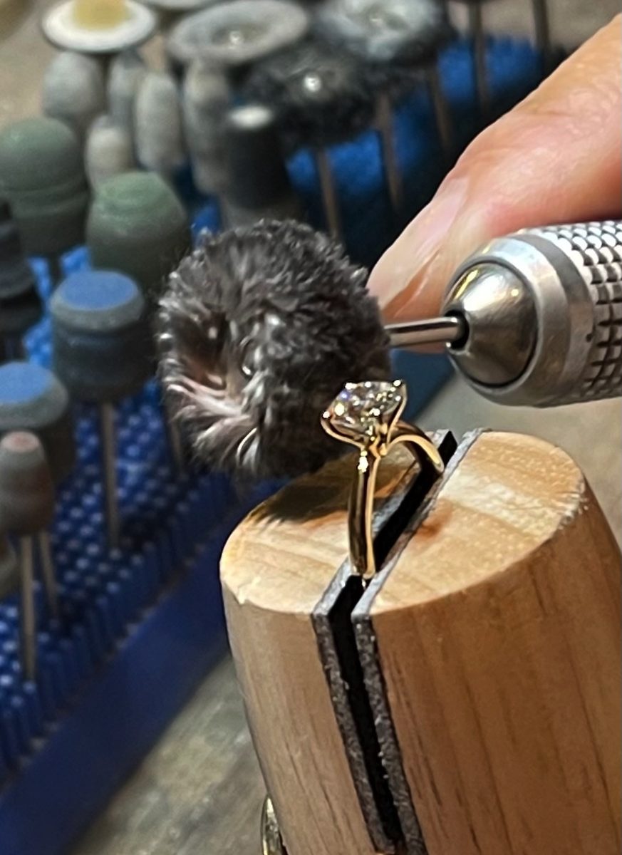 A yellow-gold solitaire on the polishing mop, made to order.